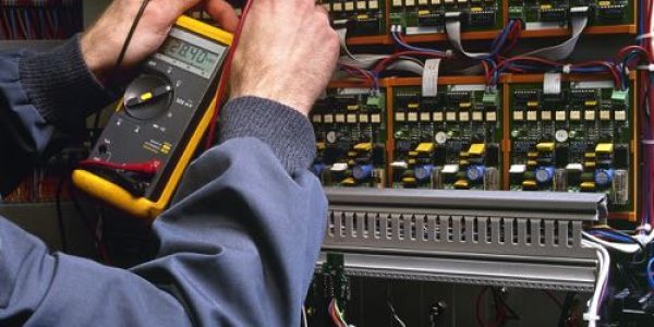 electrician-testing-industrial-machine-2021-08-26-22-28-48-utc Commercial Electrical Maintenance in Flower Mound
